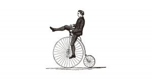 Grabado de un hombre en una bicicleta antigua